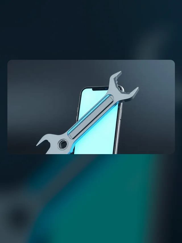 Llave de ajuste brillante en cian junto a un celular con pantalla en blanco sobre fondo grafito